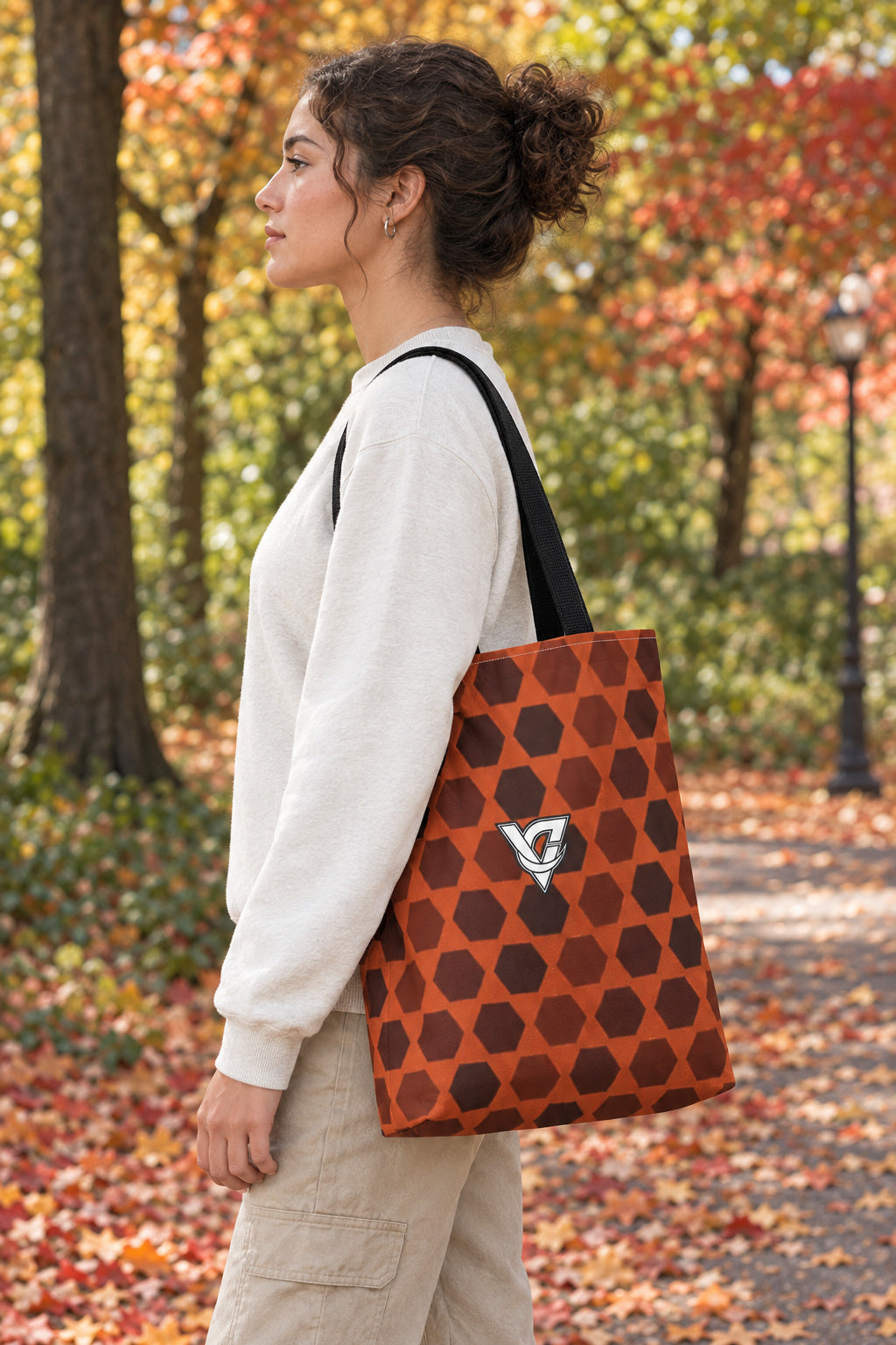 Auburn Hex Grid Tote Bag — All-Over Print Gym & Everyday Tote, AI-generated side-profile product mockup on a fictional adult model