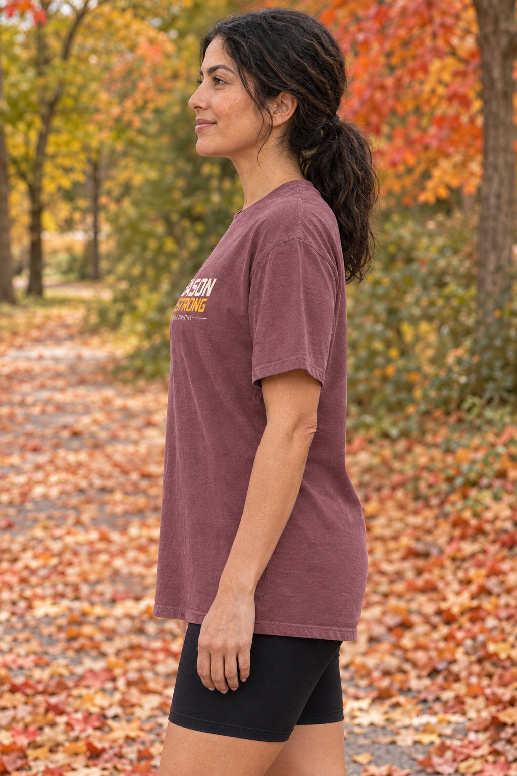 Season Of Strong | Women's Garment-Dyed Graphic Tee, AI-generated side-profile product mockup on a fictional adult model