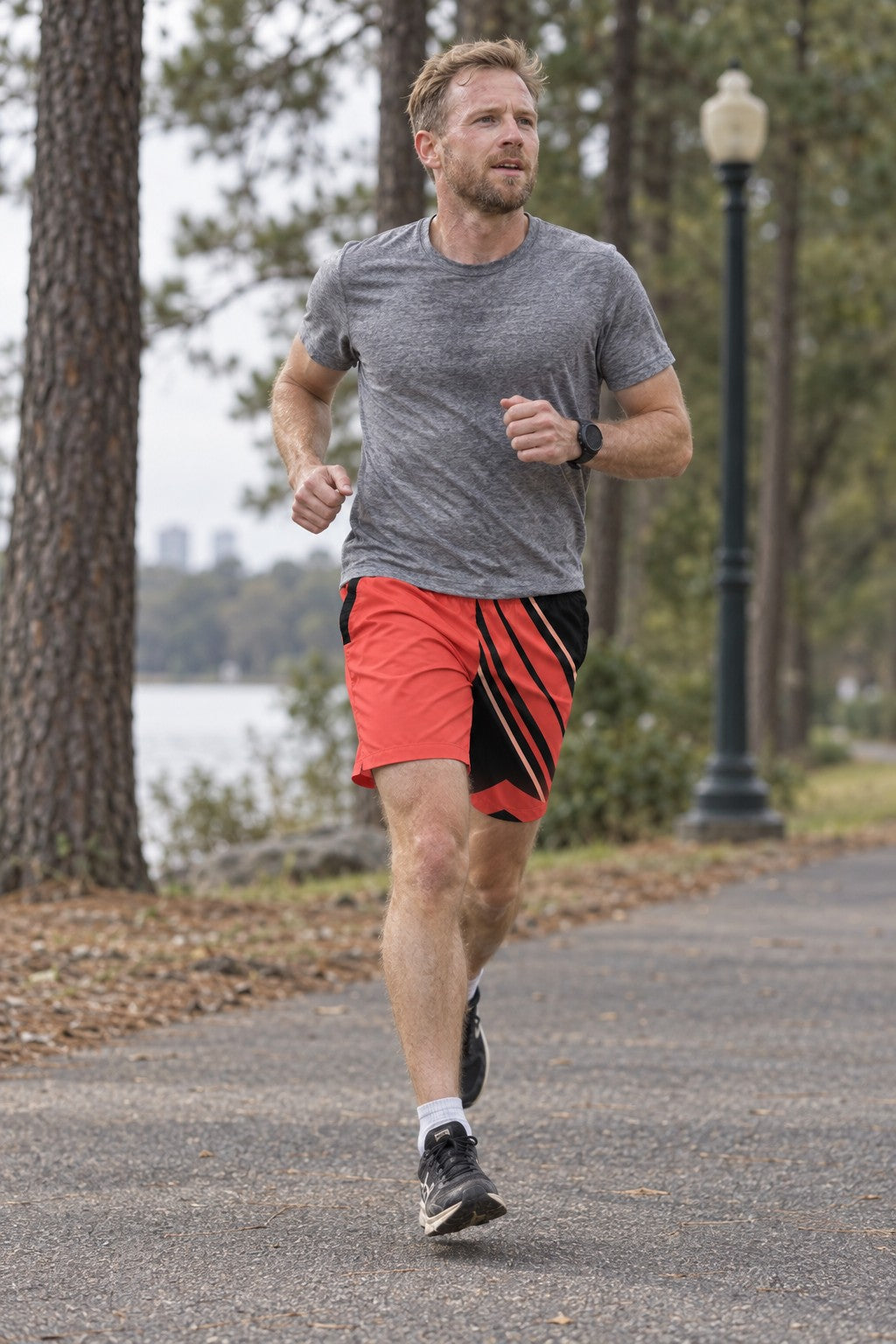 Runner wearing Men's Sunset Coral & Black Running Jogger Shorts with Pockets — Athletic Performance AOP
