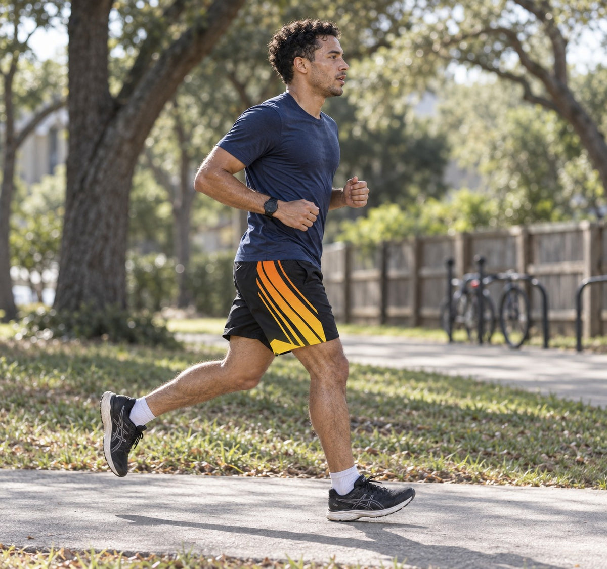 Runner wearing Men's Black Flame Orange & Yellow Running Jogger Shorts with Pockets — Athletic Performance AOP — side view