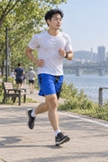 Runner wearing Men's Royal Blue & Black Geometric Jogger Athletic Shorts with Pockets