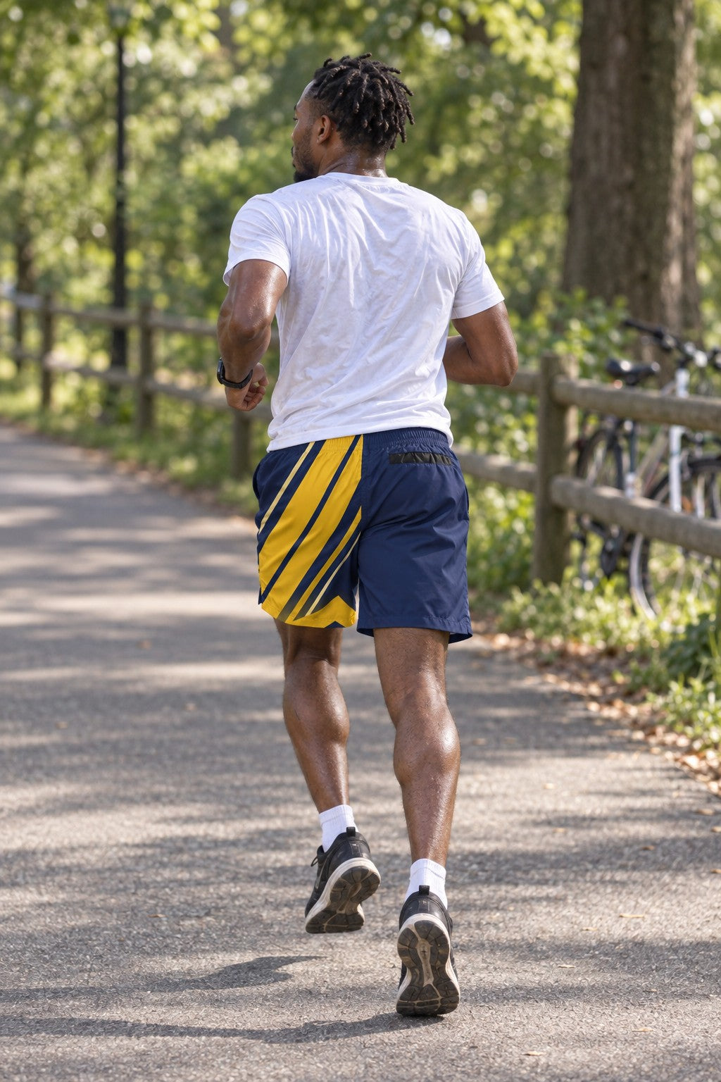 Runner wearing Men's Navy & Gold Running Jogger Shorts with Pockets — Athletic Performance AOP — rear view