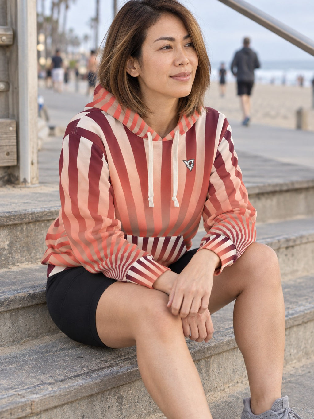 Woman wearing the Coral Sunburst Women's Pullover Hoodie