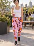 Woman wearing Vantacore Tangerine Spots all-over print joggers, front view