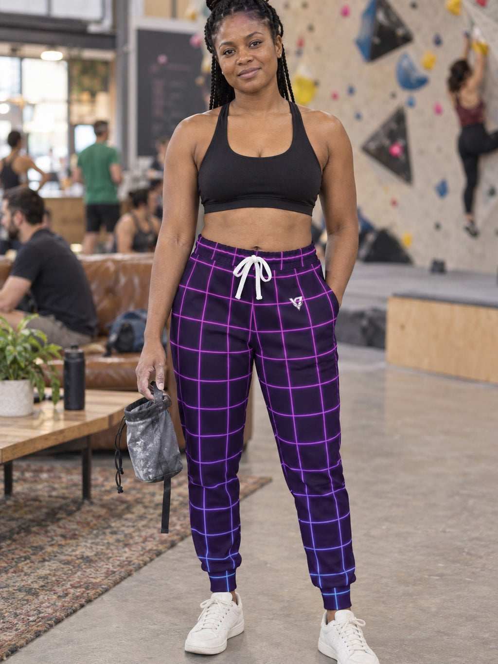 Woman wearing Vantacore Neon Grid all-over print joggers, front view