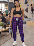 Woman wearing Vantacore Neon Grid all-over print joggers, front view