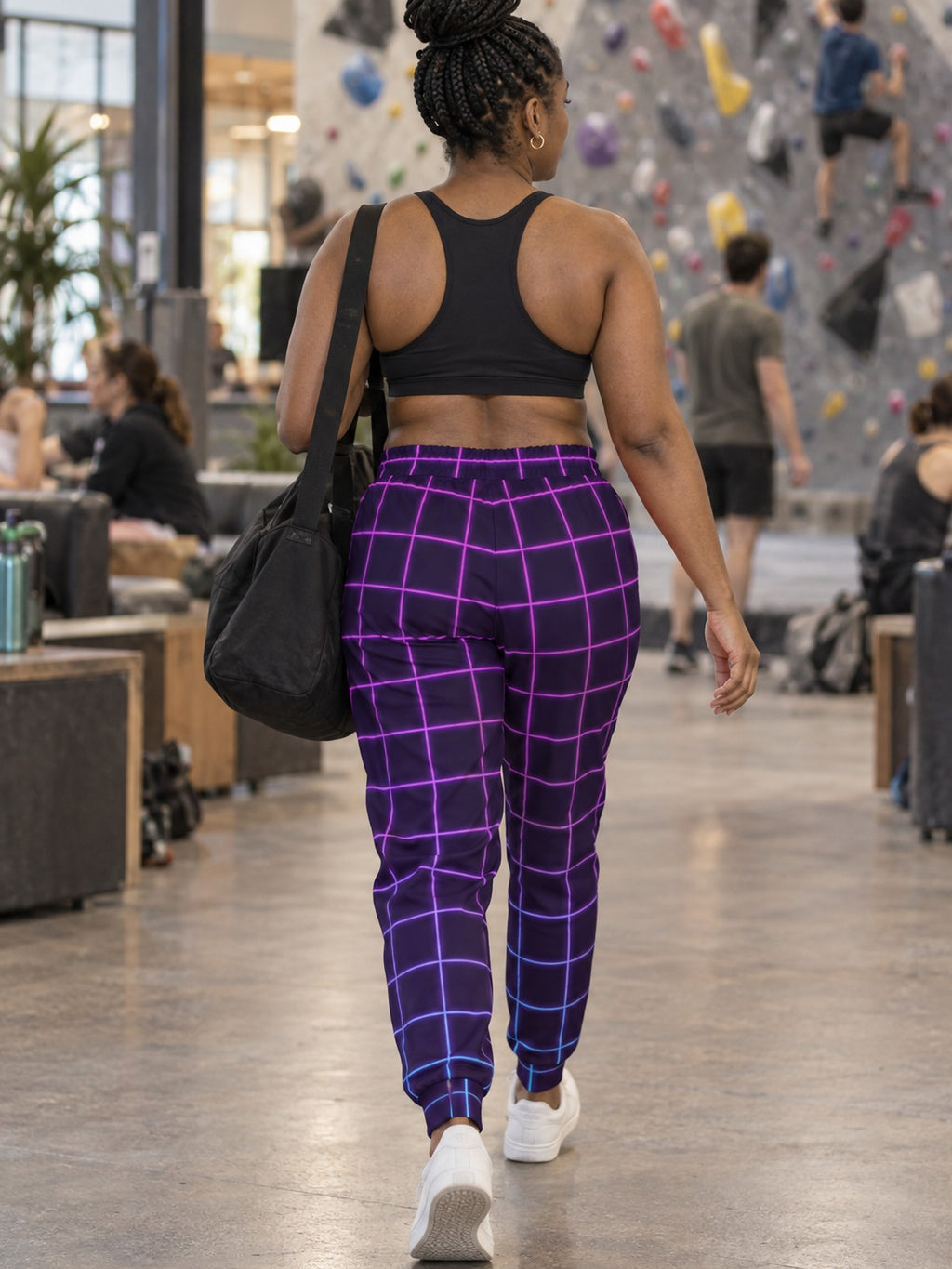 Woman wearing Vantacore Neon Grid all-over print joggers, back view
