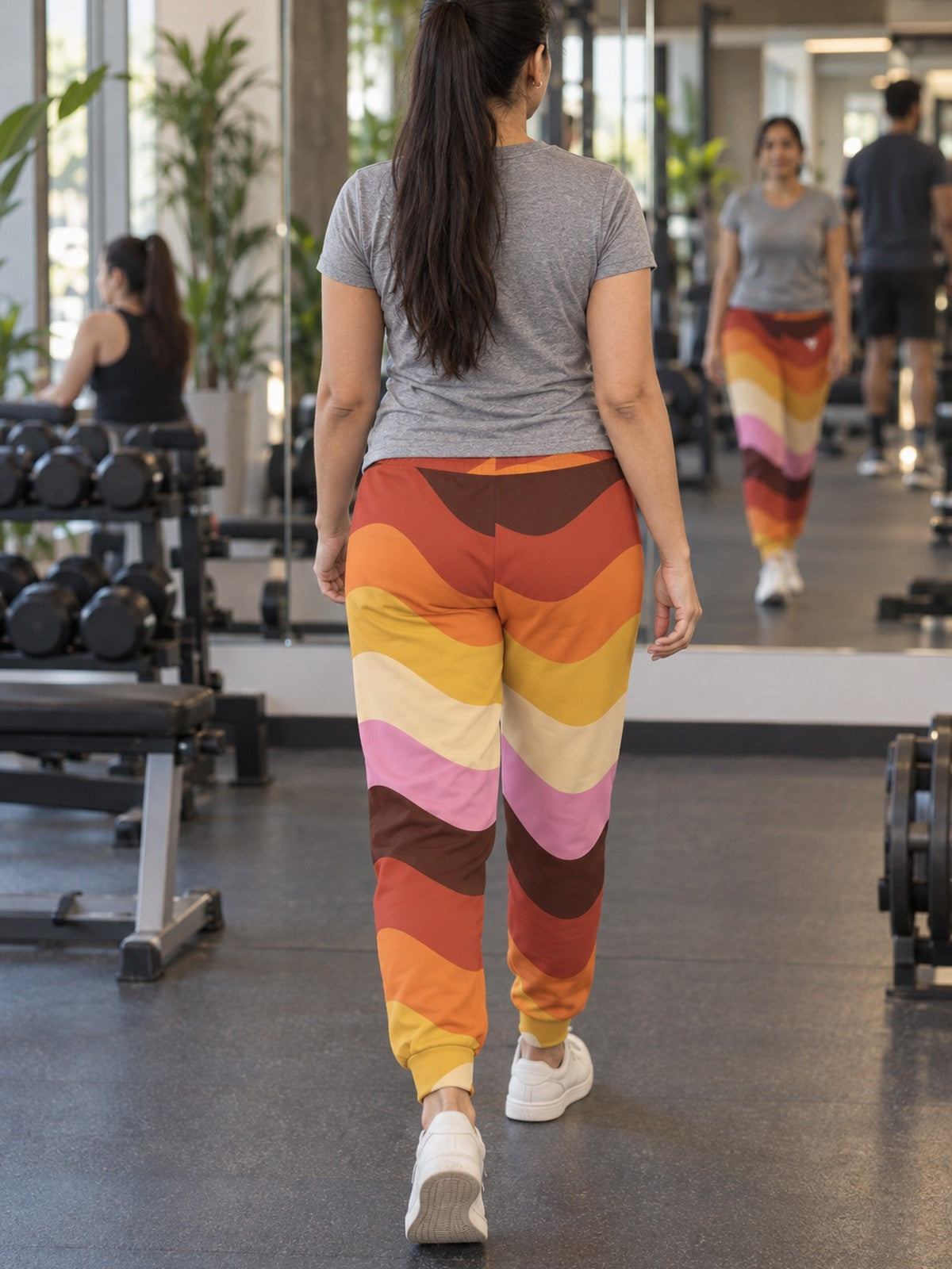 Woman wearing Vantacore Retro Waves all-over print joggers, back view