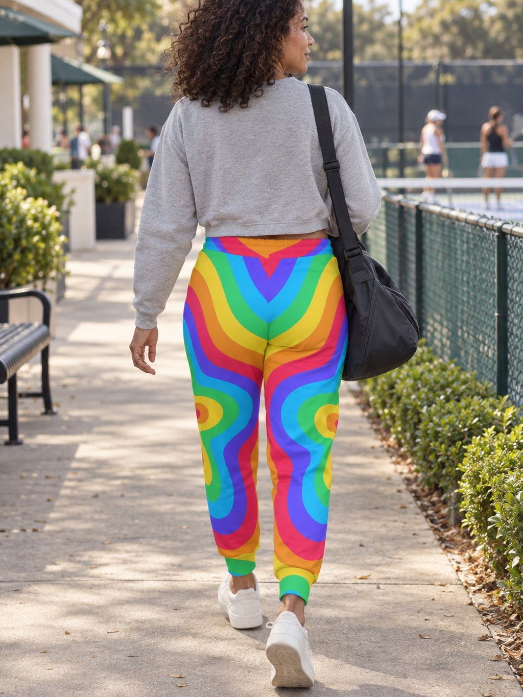 Woman wearing Vantacore Groovy Rings all-over print joggers, back view