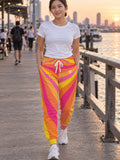 Woman wearing Vantacore Sunburst Rays all-over print joggers, front view