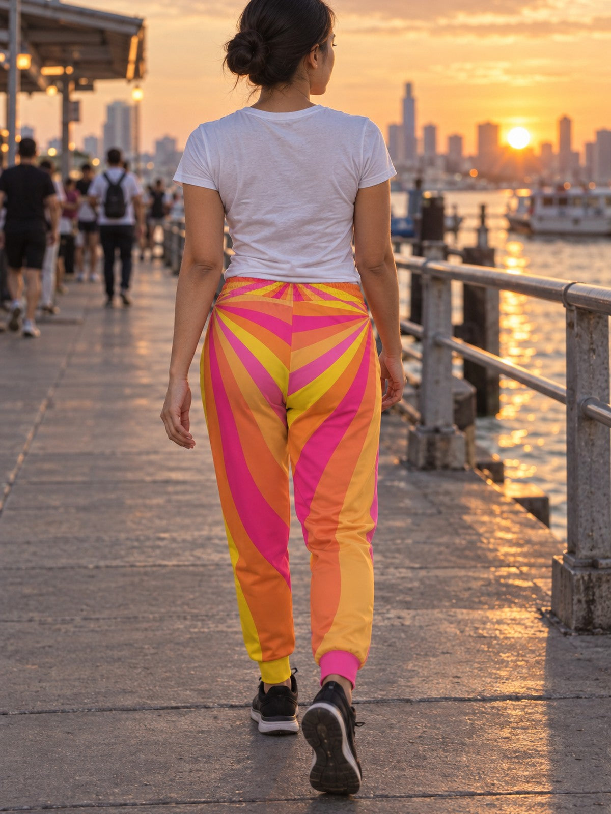 Woman wearing Vantacore Sunburst Rays all-over print joggers, back view