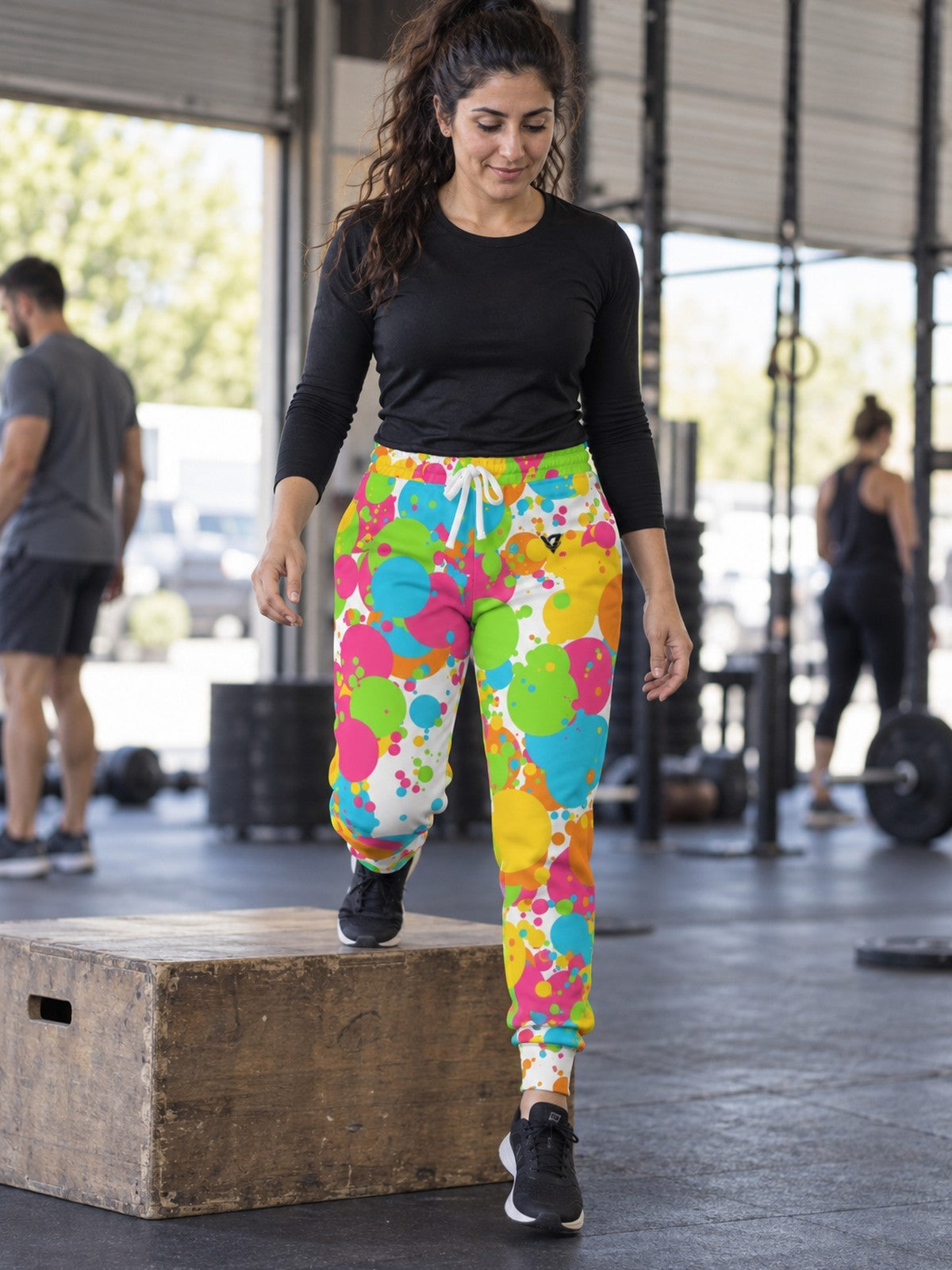Woman wearing Vantacore Citrus Splash all-over print joggers, front view