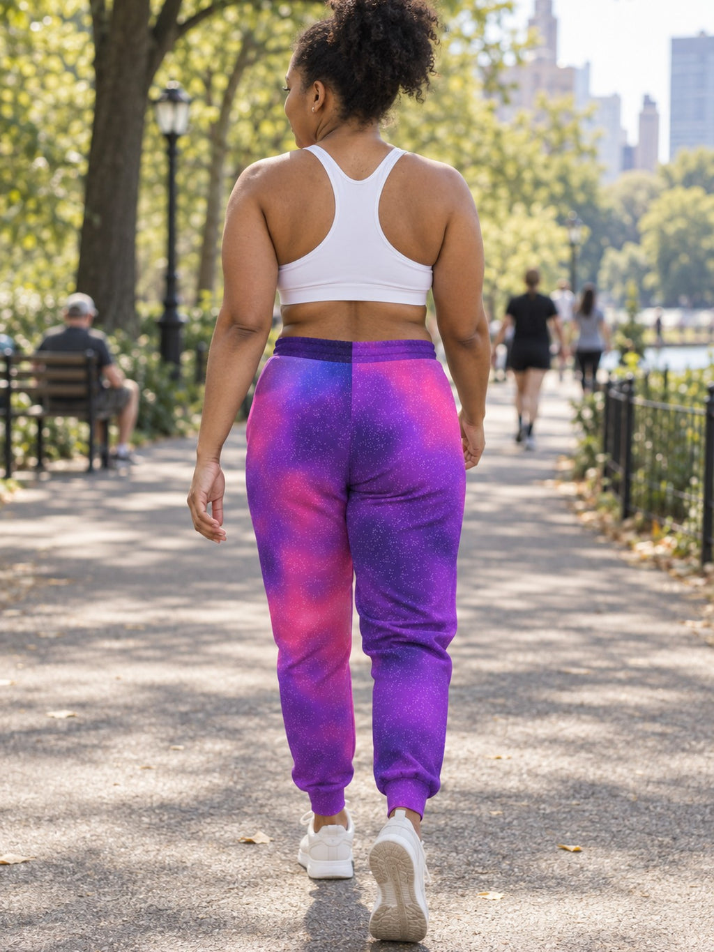 Woman wearing Vantacore Galaxy Glow all-over print joggers, back view