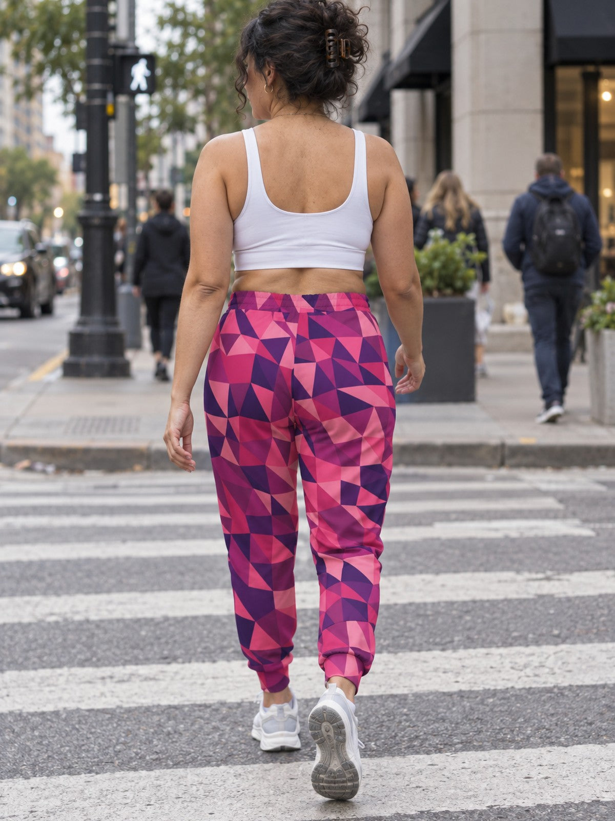 Woman wearing Vantacore Berry Mosaic all-over print joggers, back view