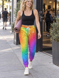 Woman wearing Vantacore Rainbow Tie-Dye all-over print joggers, front view