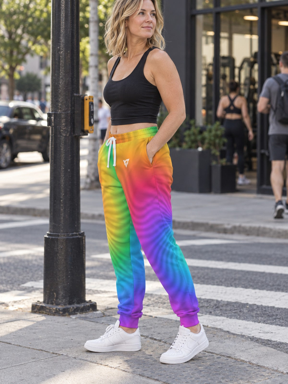 Woman wearing Vantacore Rainbow Tie-Dye all-over print joggers, side view