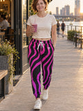 Woman wearing Vantacore Electric Zebra all-over print joggers, front view