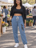 Woman wearing Vantacore LIFT Zone Club graphic sweatpants in Blue Jean
