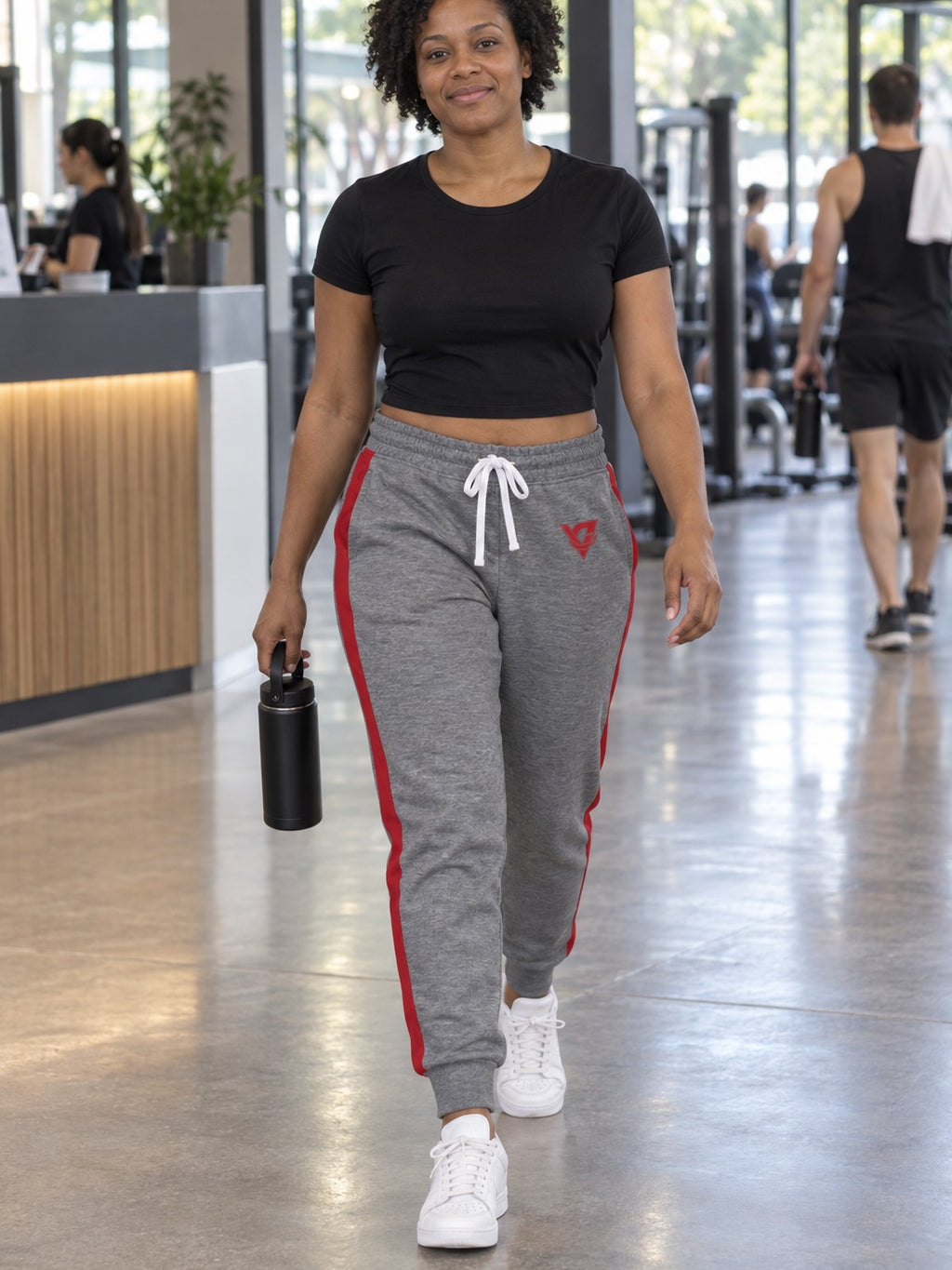 Woman wearing Vantacore grey red-stripe athletic joggers, front view