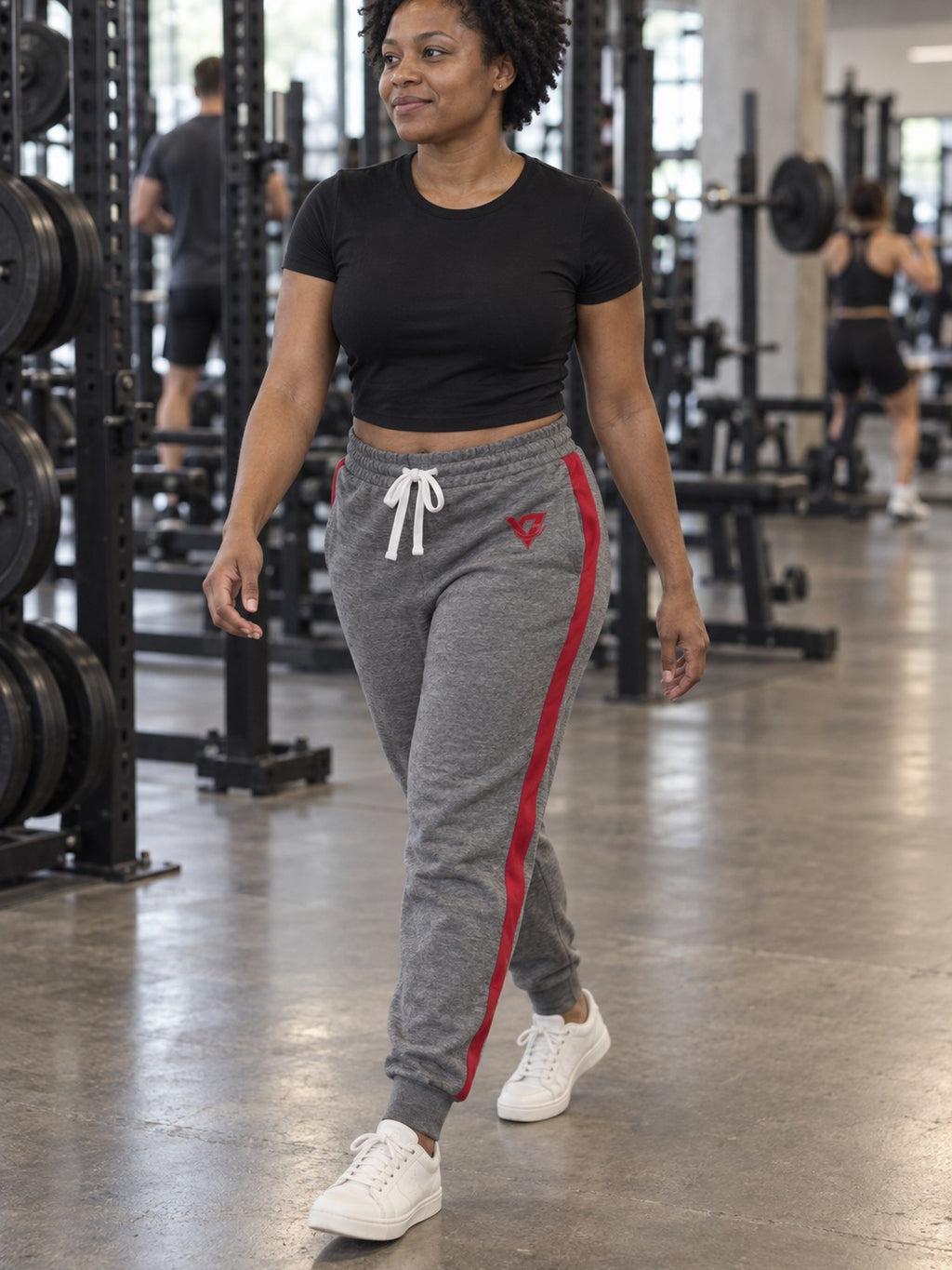 Woman wearing Vantacore grey red-stripe athletic joggers, three-quarter view