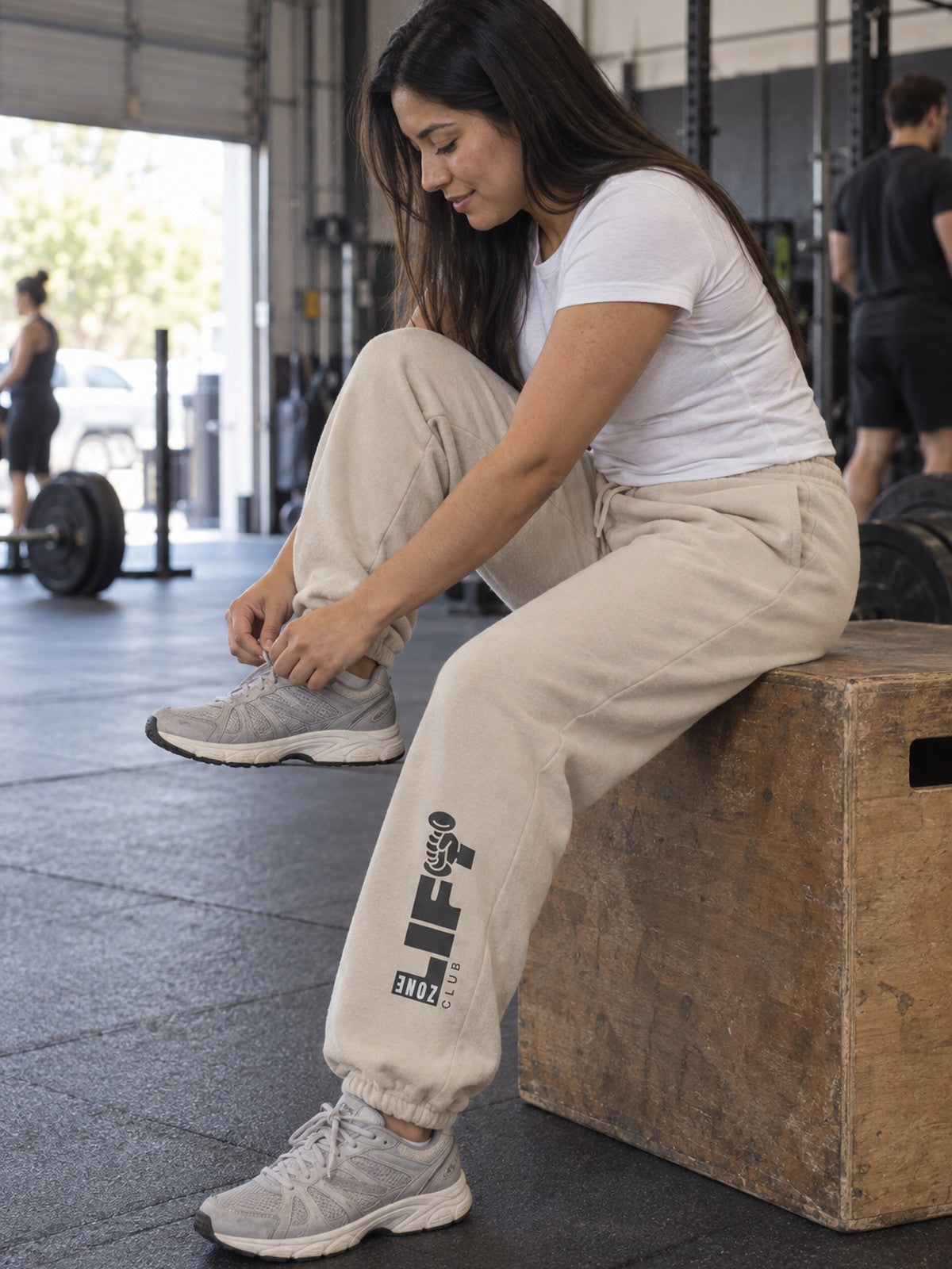 Woman wearing Vantacore LIFT Zone Club graphic sweatpants in Dust, side view