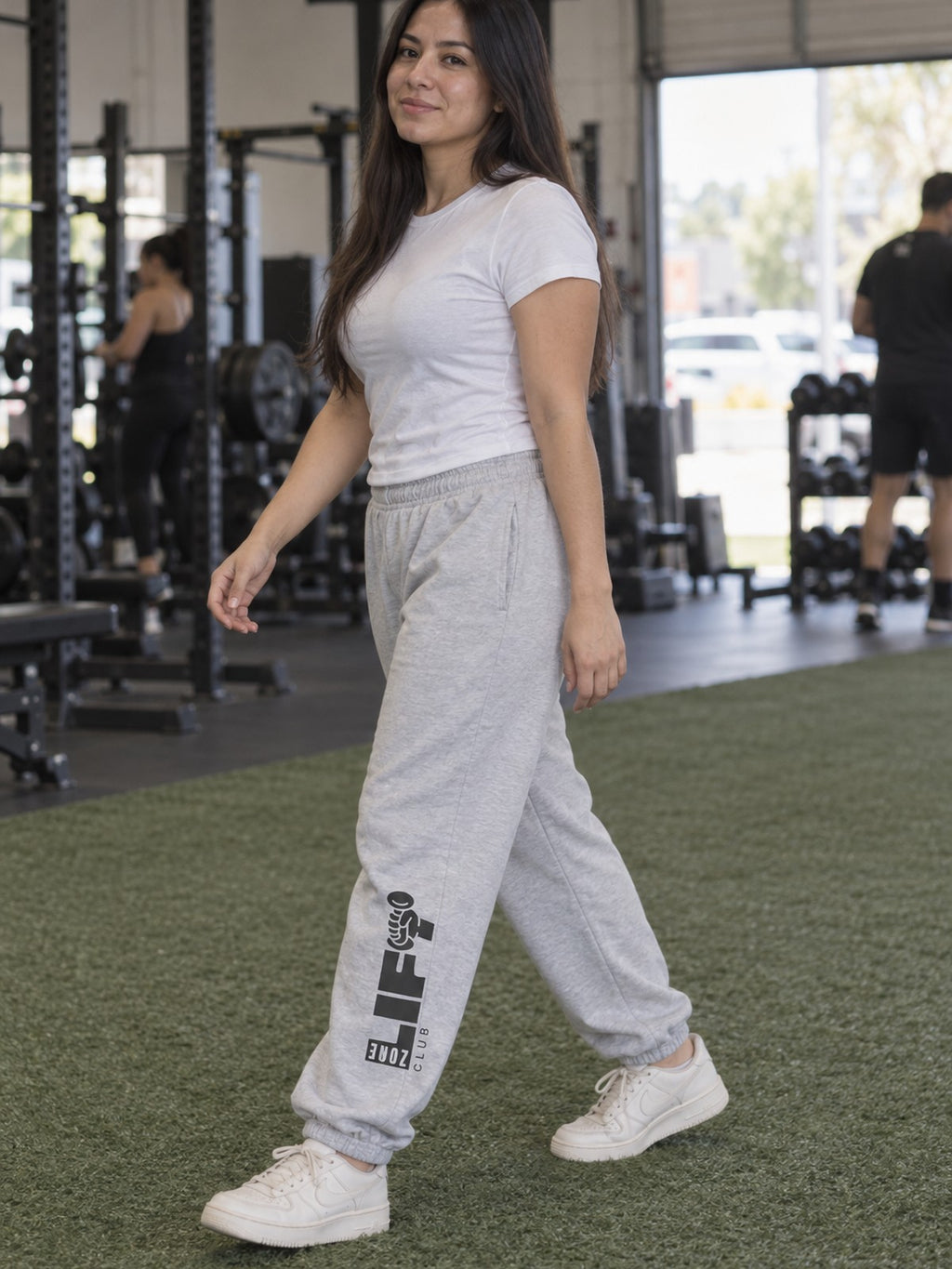 Woman wearing Vantacore LIFT Zone Club graphic sweatpants in Athletic Heather, three-quarter view