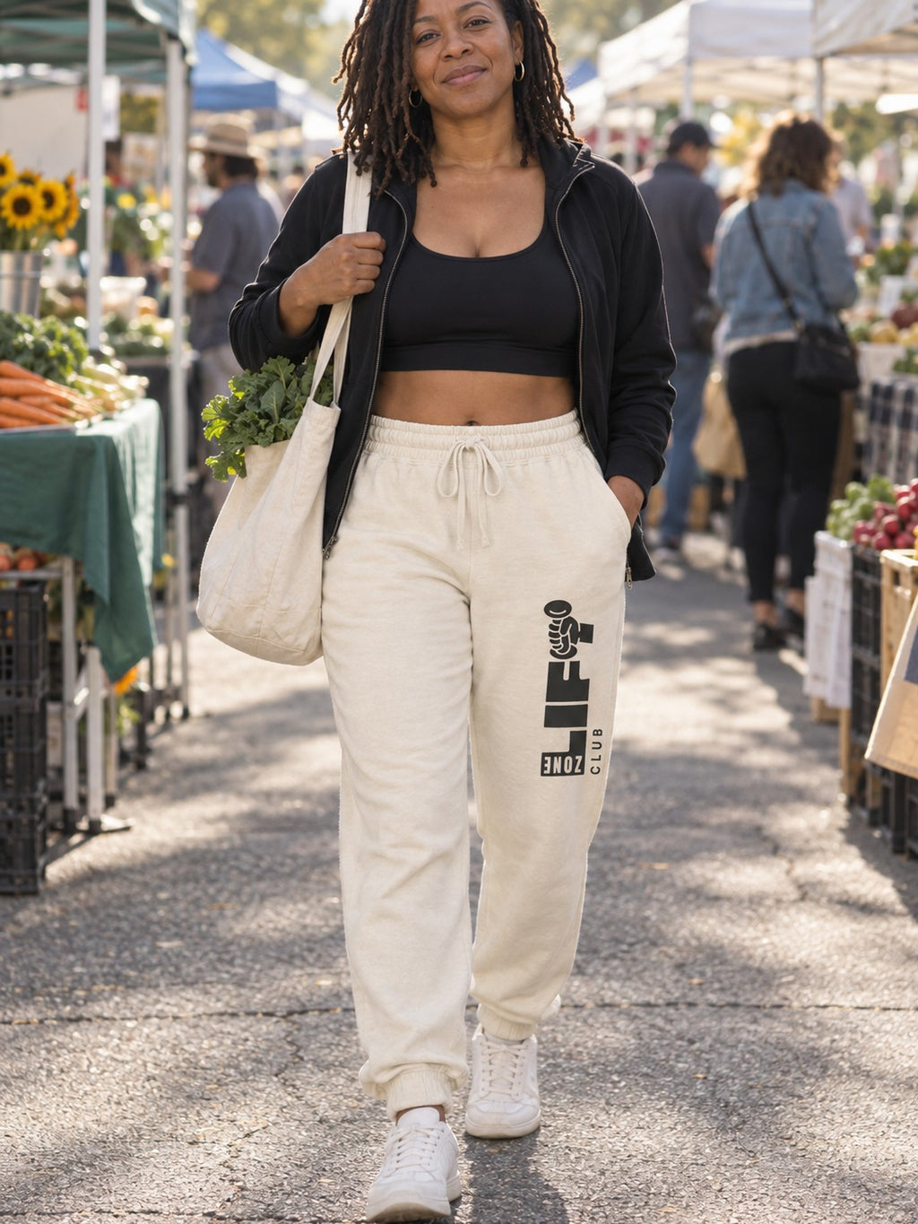 Woman wearing Vantacore LIFT Zone Club graphic sweatpants in Ivory, front view