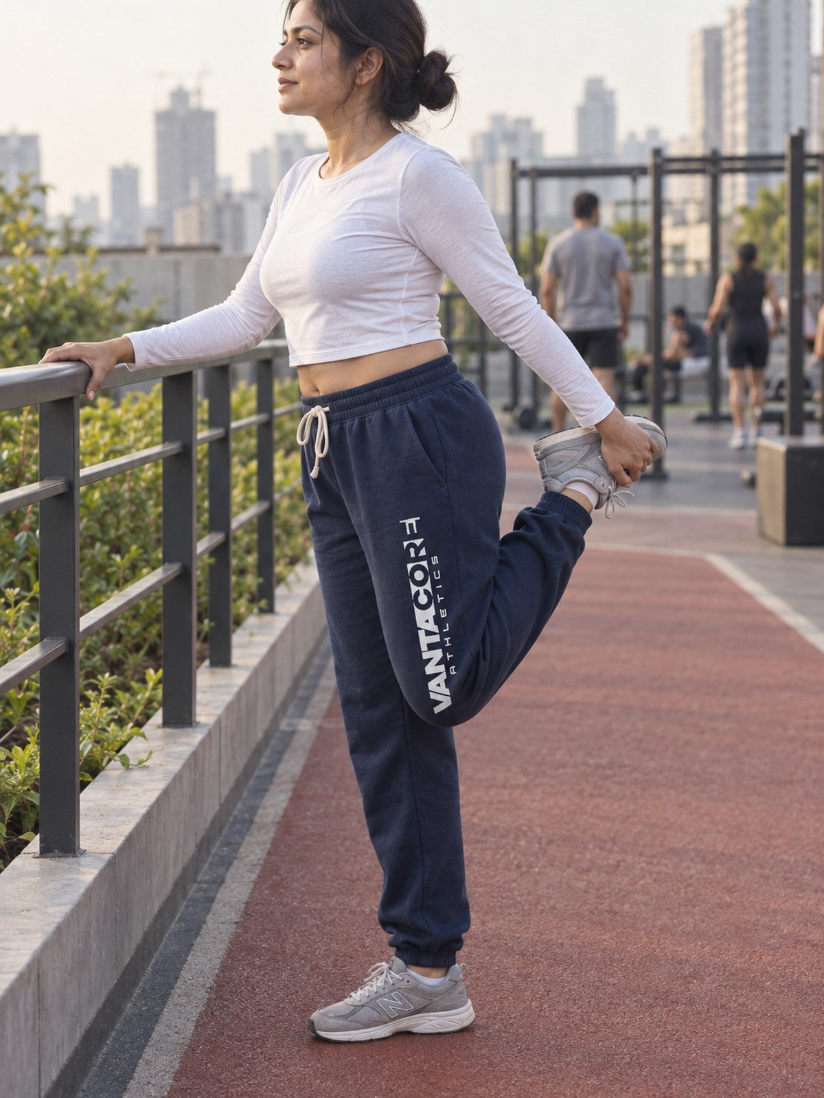 Woman wearing Vantacore Vantacore Athletics logo sweatpants in Navy, side view