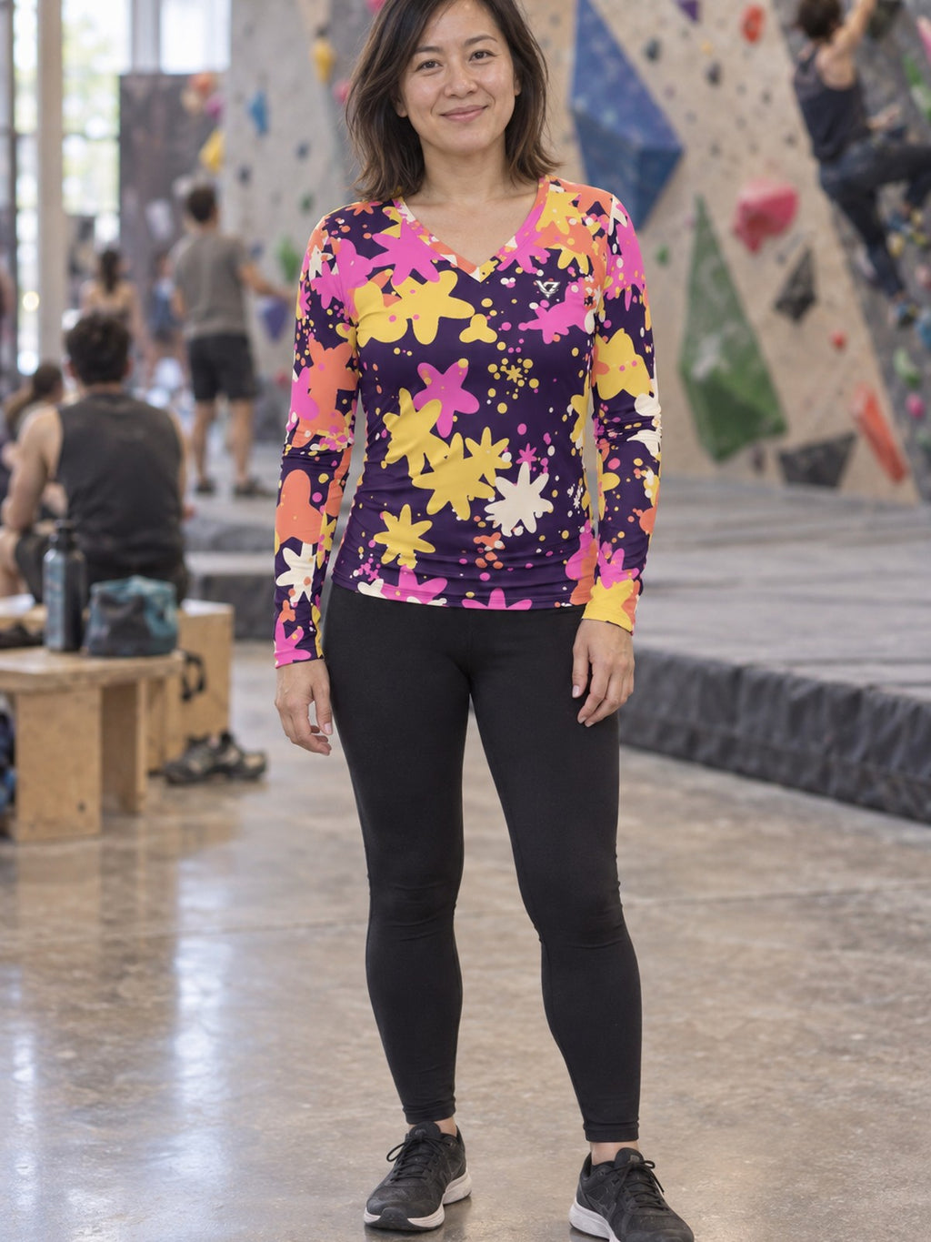 Woman wearing the Sunset Splatter Women's Long Sleeve V-Neck Athletic Top