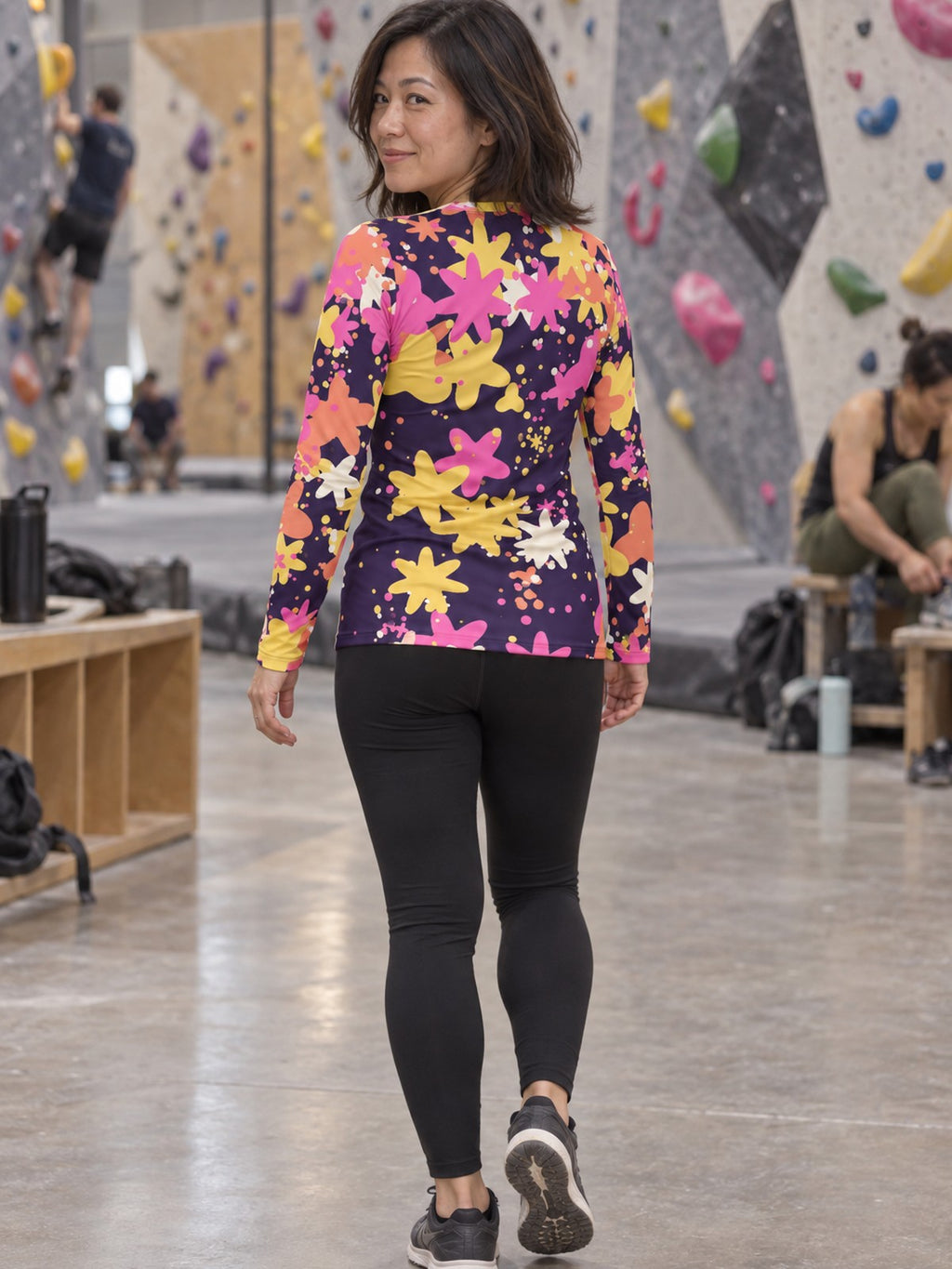 Woman wearing the Sunset Splatter Women's Long Sleeve V-Neck Athletic Top