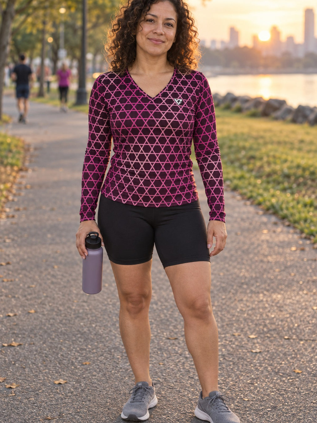 Woman wearing the Berry Hex Grid Women's Long Sleeve V-Neck Athletic Top