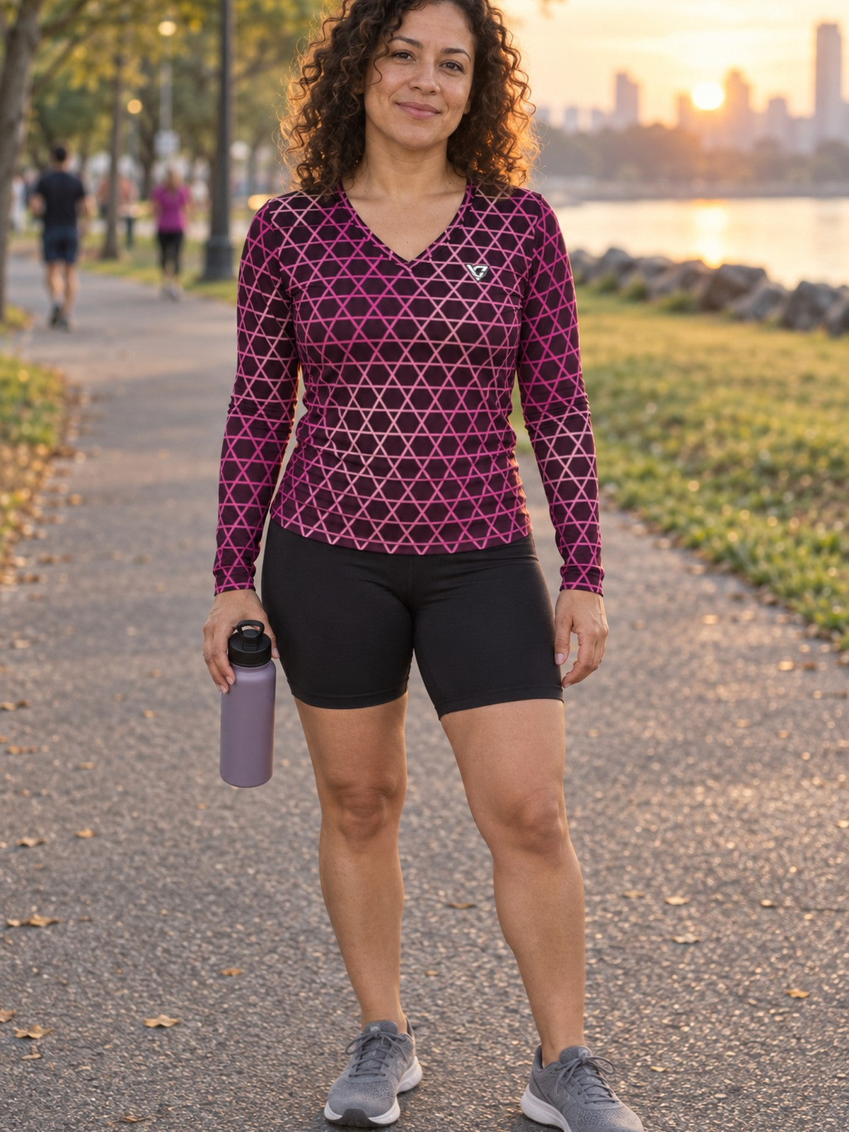 Woman wearing the Berry Hex Grid Women's Long Sleeve V-Neck Athletic Top