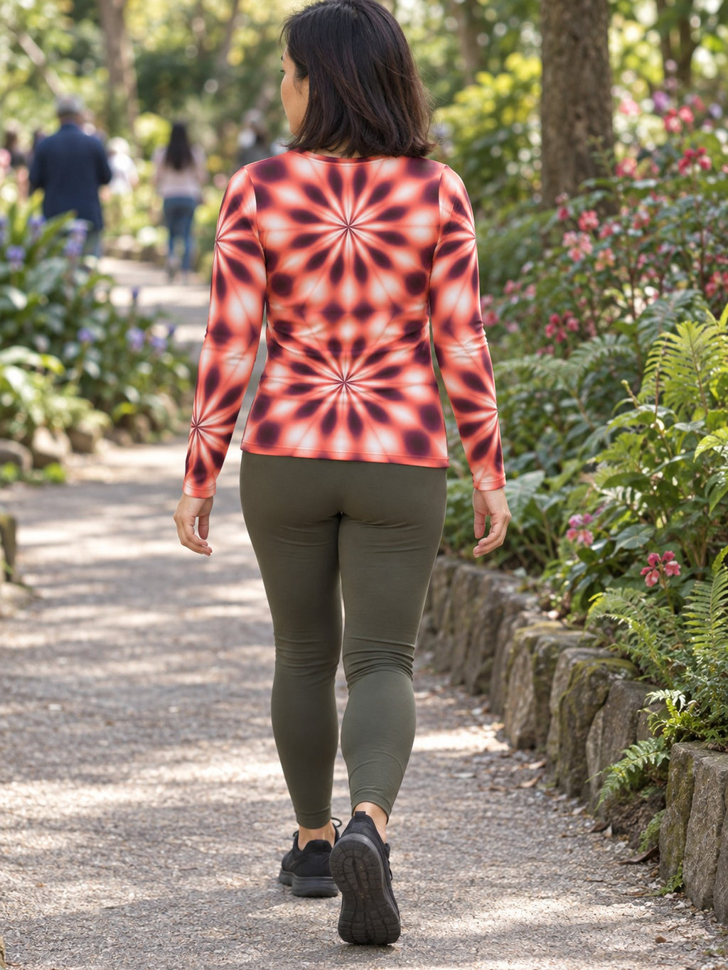 Woman wearing the Coral Kaleidoscope Women's Long Sleeve V-Neck Athletic Top