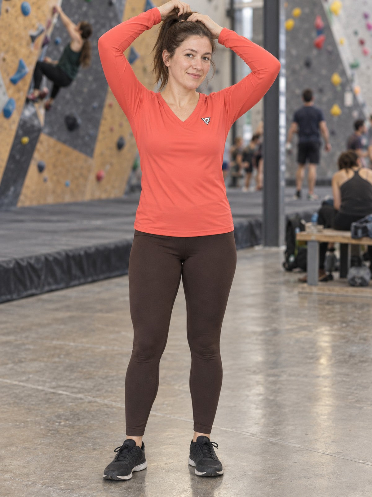 Woman wearing the Coral Essential Women's Long Sleeve V-Neck Athletic Top