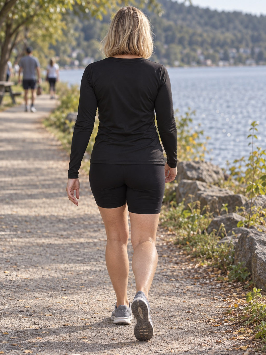 Woman wearing the Jet Black Essential Women's Long Sleeve V-Neck Athletic Top