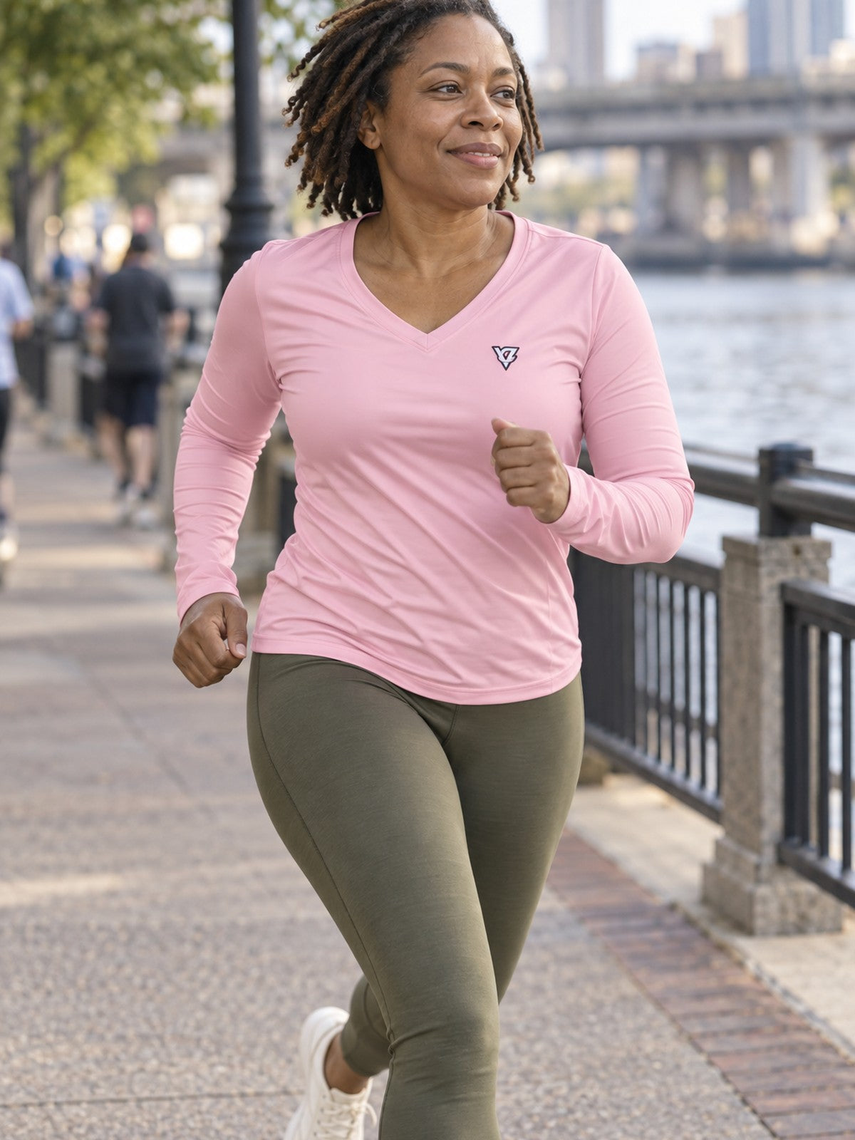 Woman wearing the Blush Essential Women's Long Sleeve V-Neck Athletic Top
