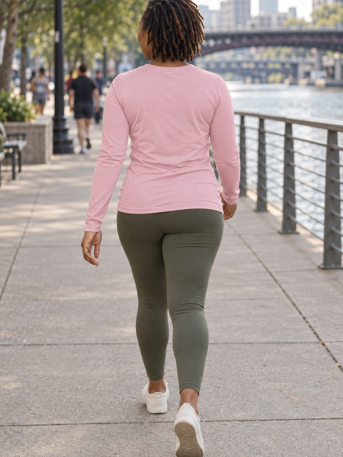 Woman wearing the Blush Essential Women's Long Sleeve V-Neck Athletic Top