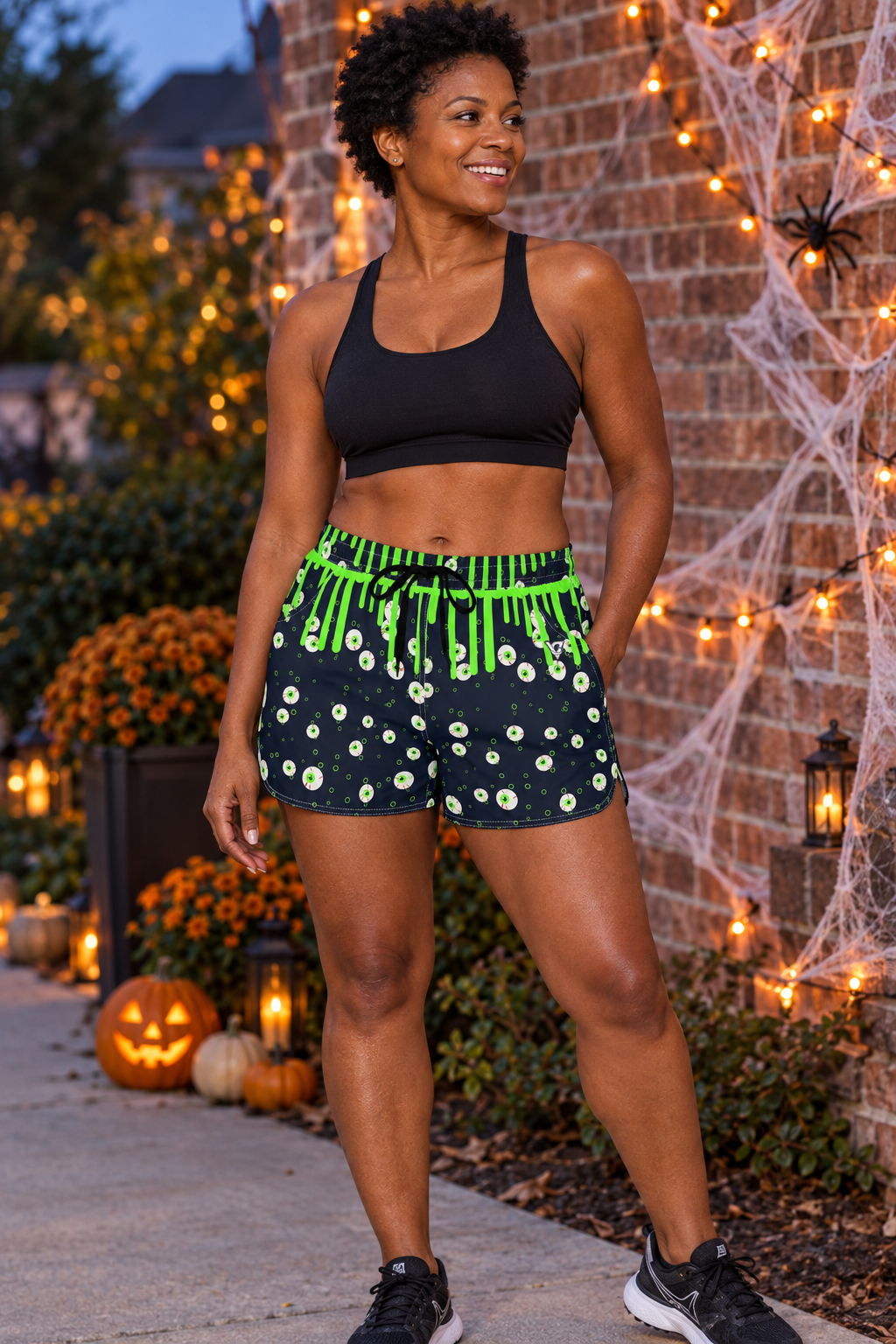 Halloween Ghostly Night Slime Drip women's lightweight athletic shorts worn on a model