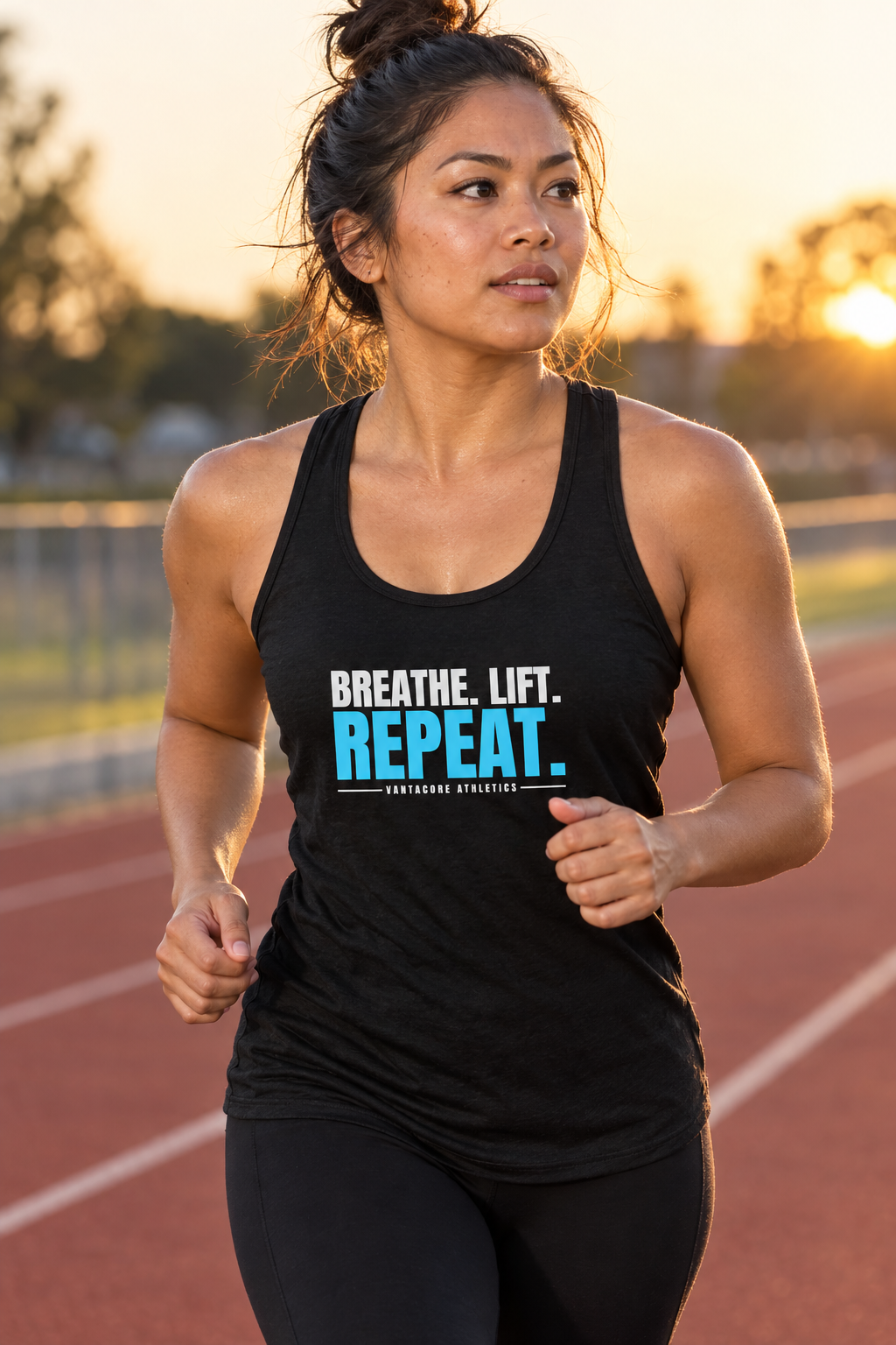 Breathe. Lift. Repeat. women's racerback performance tank top worn on a model