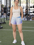 Woman wearing the Halftone Fade relaxed all-over print shorts – front view