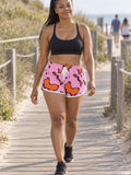 Woman wearing the Tangerine Spots relaxed all-over print shorts – front view