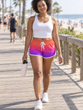 Woman wearing the Sunset Ombre relaxed all-over print shorts – front view